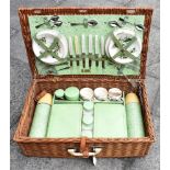 A BREXTON WICKER PICNIC HAMPER with contents, comprising six pottery cups, saucers and tea plates;