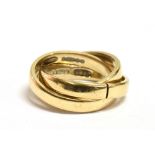 A 9CT GOLD TRINITY RING comprising three interlocked yellow gold rings, the shank fitted with