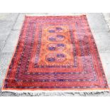 TWO MACHINE MADE RED GROUND RUGS 97cm x 140cm and 132cm x 177cm