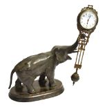 AN EARLY 20TH CENTURY CAST METAL ELEPHANT MYSTERY CLOCK the upraised trunk supporting a Junghans