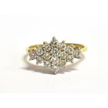 AN 18CT GOLD DIAMOND PLAQUE RING The plaque set with 15 small round cut diamonds each measuring 0.