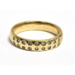 A DIAMOND ACCENTED HALF ETERNITY RING the ring with faded hallmark to the yellow gold shank, band