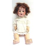 AN ALT, BECK & GOTTSCHALCK BISQUE SOCKET HEAD DOLL with a dark brown wig, sleeping brown glass eyes,