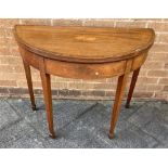 A MAHOGANY DEME LUNE FOLDOVER CARD TABLE with red beize and raised on square tapering legs H 74cm