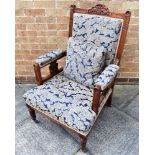 A RE-UPHOLSTERED EDWARDIAN CARVED WALNUT FRAMED ARMCHAIR on turned front supports Condition Report :