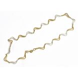 A 9CT YELLOW AND WHITE GOLD CHOKER NECKLACE The necklace in open work zig-zag design, length approx.