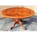 A WALNUT OVAL LOO TABLE raised on central column, the top measuring 128cm x 93cm, and the table