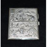 AN INDIAN SILVER CARD CASE The case embossed with village scene to include elephant with a
