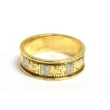A 9CT GOLD ENGRAVED PATTERN BAND RING with white gold detail, the ring with engraved flora and