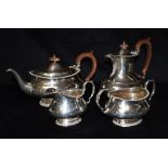 AN EDWARDIAN FOUR PIECE SILVER TEA SET The set comprising a teapot, hot water jug/coffee pot, a