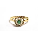 A 9CT GOLD, EMERALD AND GOSHENITE FLOWER HEAD RING the flower head in an openwork mount measuring