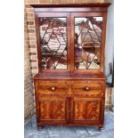 A WILLIAM IV FIGURED MAHOGANY SECRETAIRE BOOKCASE the astragal glazed bookcase enclosing two bays of