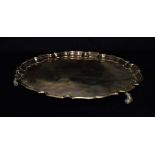 A GEORGE VI SILVER SALVER the salver on three scrolled feet with pie crust border, hallmarked for