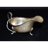 A GEORGE V SILVER GRAVY BOAT on three splayed feet, hallmarked for Birmingham 1931, maker B.B. S Ld,