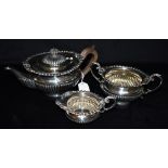 A LATE VICTORIAN SILVER THREE PIECE TEA SET the set comprising a teapot, twin handled bowl, and a