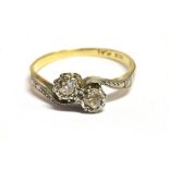 AN 18CT GOLD PLATINUM TWO STONE EUROPEAN CUT CROSSOVER RING The two diamonds illusion set, measuring