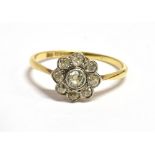 AN ART DECO 18CT GOLD DIAMOND DAISY RING the daisy comprising eight outer old cut diamonds