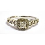 A 9CT WHITE GOLD DIAMOND SET DRESS RING The ring set with numerous diamond accents with flower