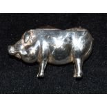 A WHITE METAL PIG PIN CUSHION length 5.5cm, height 3cm