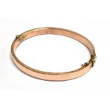 AN EDWARDIAN ROSE GOLD BANGLE The bangle hallmarked for Birmingham 1904 Maker M.W Ld, 0.5 cm wide,