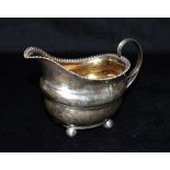 A GEORGE III SILVER SAUCE BOAT the boat on four ball feet with patterned rim, hallmarked for