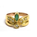 A STAMPED 14K EMERALD AND DIAMOND DRESS RING the ring set with a navette cut emerald and seven small