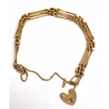 A MARKED 9CT HEART PADLOCK THREE GATE BRACELET the bracelet fitted with a safety chain and measuring