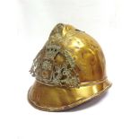 A FRENCH FIREMAN'S BRASS ADRIAN HELMET with embossed brass helmet plate 'SAPEURS POMPIERS ST.