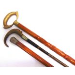 A MALACCA CANE with a silver top, 86cm long; together with two walking sticks, the longest 93.5cm