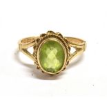 A 9CT GOLD GREEN AQUAMARINE COCKTAIL RING the oval faceted aquamarine measuring 0.9 x 0.6cm