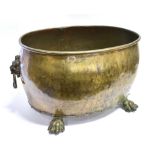 A LARGE BRASS OVAL LOG BIN with lion mask handles on four paw feet, 63cm x 46cm, 34cm high Condition