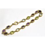 A GEM SET BRACELET the bracelet set with fifteen oval facetted coloured gemstones, mounted in open