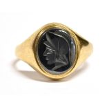 A 9CT GOLD INTAGLIO RING The dark grey Intaglio carved with a roman head measuring 1.2 x 1 cm on a
