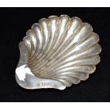 A LATE VICTORIAN SILVER SHELL SHAPED DISH the dish on three ball feet, hallmarked for London 1900,