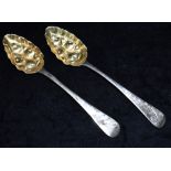 A MATCHED PAIR OF GEORGE III SILVER BERRY SPOONS the spoons with bright cut handles and gilt