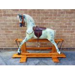 A HADDON ROCKERS ROCKING HORSE of fibre glass construction, the side-glancing head with an open