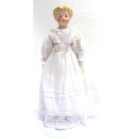 A GERMAN BISQUE SHOULDER HEAD DOLL with moulded and painted blonde hair, painted blue eyes,