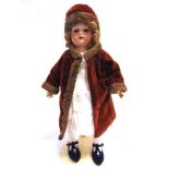 A SIMON & HALBIG FOR KAMMER & REINHARDT BISQUE SOCKET HEAD DOLL with a long, curled light brown wig,