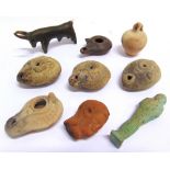 ASSORTED ANTIQUITIES comprising a Roman terracotta oil lamp, 8cm long, and four others, similar; and