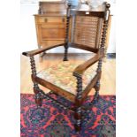 AN OAK CARVER CHAIR WITH CANED BACK