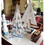 COLLECTION OF BOAT ORNAMENTS AND MODEL LIGHTHOUSE