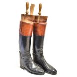 A PAIR OF GENTLEMAN'S BLACK LEATHER RIDING BOOTS with brown tops, size 10, complete with trees