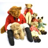 FOUR EARLY FOX TOYS all in hunting dress, the tallest 47cm high, a seated fox soft toy and a