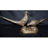 A CAST GROUP OF A COCK AND HEN PHEASANT on a shaped octagonal black marble base, 32cm high, 66cm