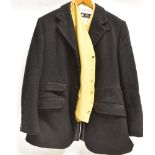 A GENTLEMAN'S BLACK HUNT COAT with check lining and B.H. black hunt buttons and a mustard coloured