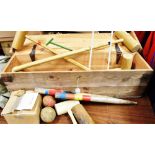 A CROQUET SET comprising four mallets, a spare mallet head, six balls, six hoops, two marker