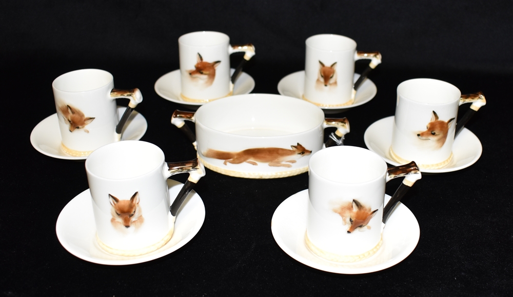 A ROYAL DOULTON REYNARD THE FOX DESIGN COFFEE SERVICE comprising six cups and saucers and an oval