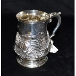 A VICTORIAN SILVER TANKARD with scroll handle and embossed with a ploughing scene and with