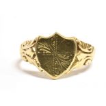 A 9CT GOLD SHIELD SIGNET RING The ring with part engraved pattern to the bezel and patterned
