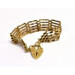 A 9CT GOLD FIVE BAR GATE BRACELET The bracelet fitted with a 9ct gold heart padlock with an engraved
